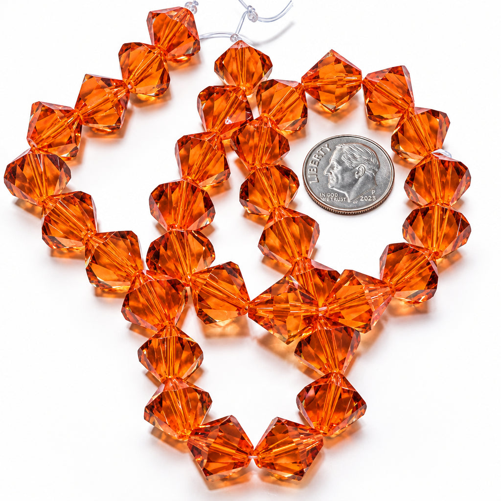 Orange faceted glass beads arranged in loops on a white background, with a silver coin placed nearby for size reference.