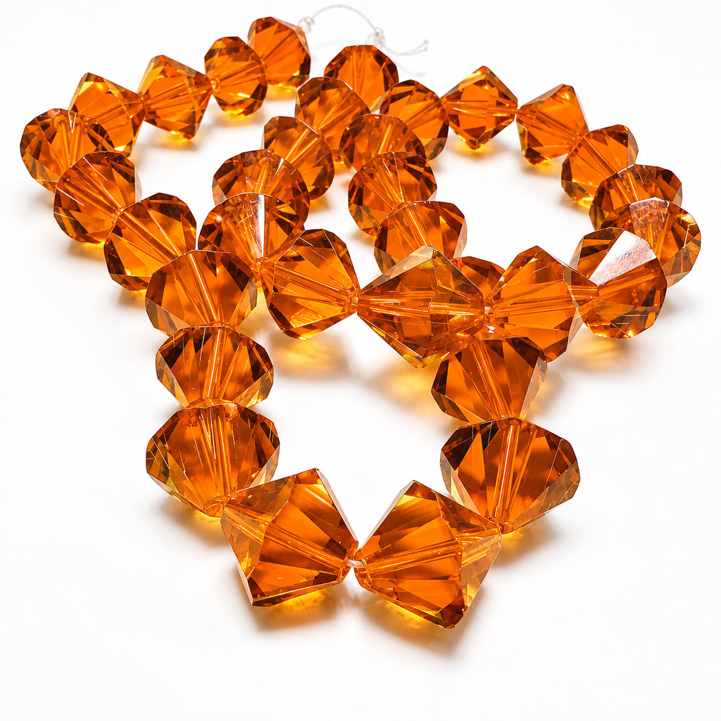 Faceted amber-orange glass beads arranged in a loose circle on a white background.