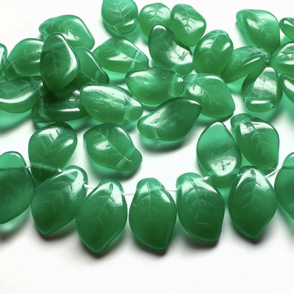 Green translucent stone beads with a smooth, polished finish and leaf-like organic shapes, arranged on a white background.