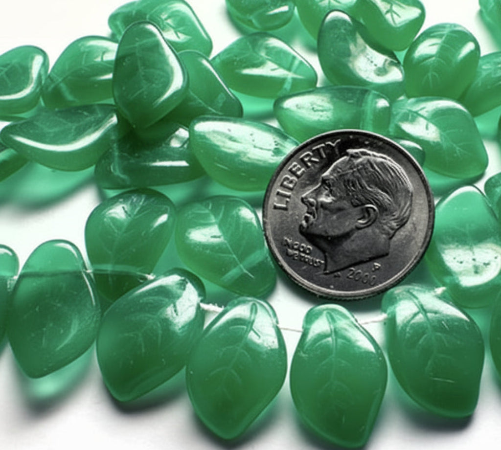 Green tumbled stone chips with a leaf shape, arranged in a circle around a silver dime for scale on a white background.