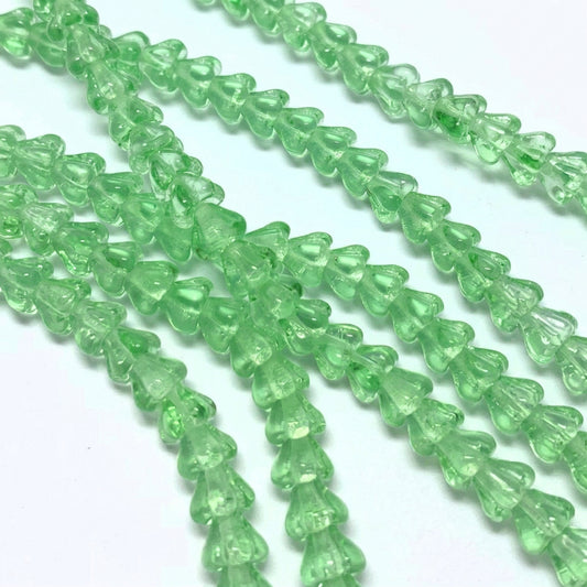 Green glass beads on a white background