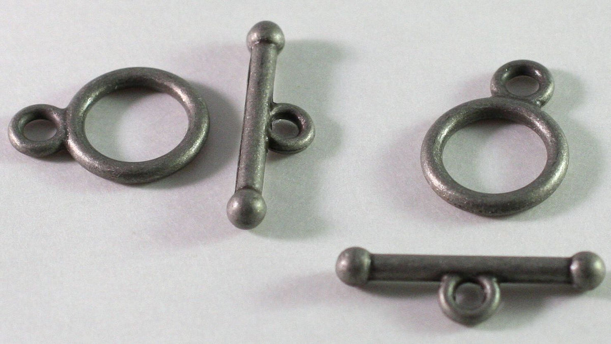 A silver-toned metal toggle clasp with a large circular ring and a straight bar with a small loop, shown on a plain light background.
