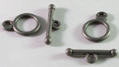A silver-toned metal toggle clasp with a large circular ring and a straight bar with a small loop, shown on a plain light background.