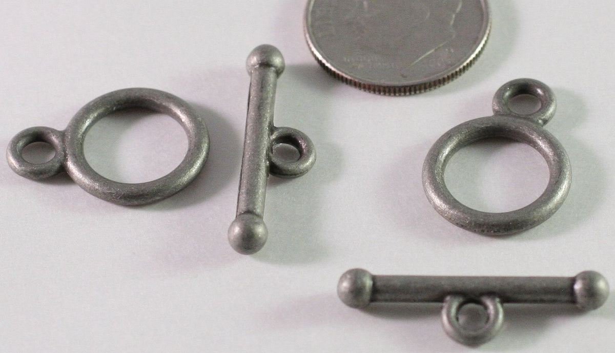 A silver-toned metal toggle clasp with a large circular ring and a straight bar with a small loop, shown on a plain light background.
