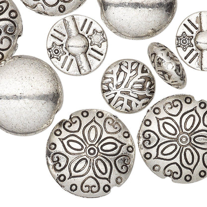 A close-up of multiple round silver-toned beads with embossed floral and geometric patterns on a plain white background.