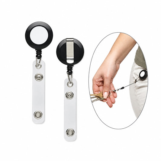 Two retractable badge reel keychains with black round reels and silver metal bars are shown on a white background, alongside an oval inset demonstrating a hand attaching a key to one of the reels.