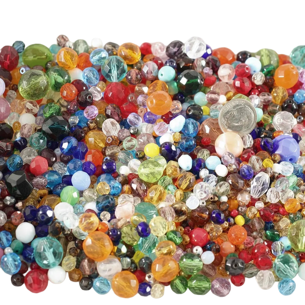 A dense pile of colorful faceted glass beads in many sizes and colors, including red, blue, green, yellow, orange, purple, pink, and clear beads, filling the frame.