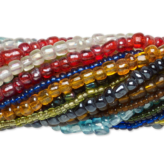 A close-up stack of faceted gemstone beads in multiple colors, including red, clear, blue, yellow, green, brown, and turquoise, arranged horizontally on a white background.