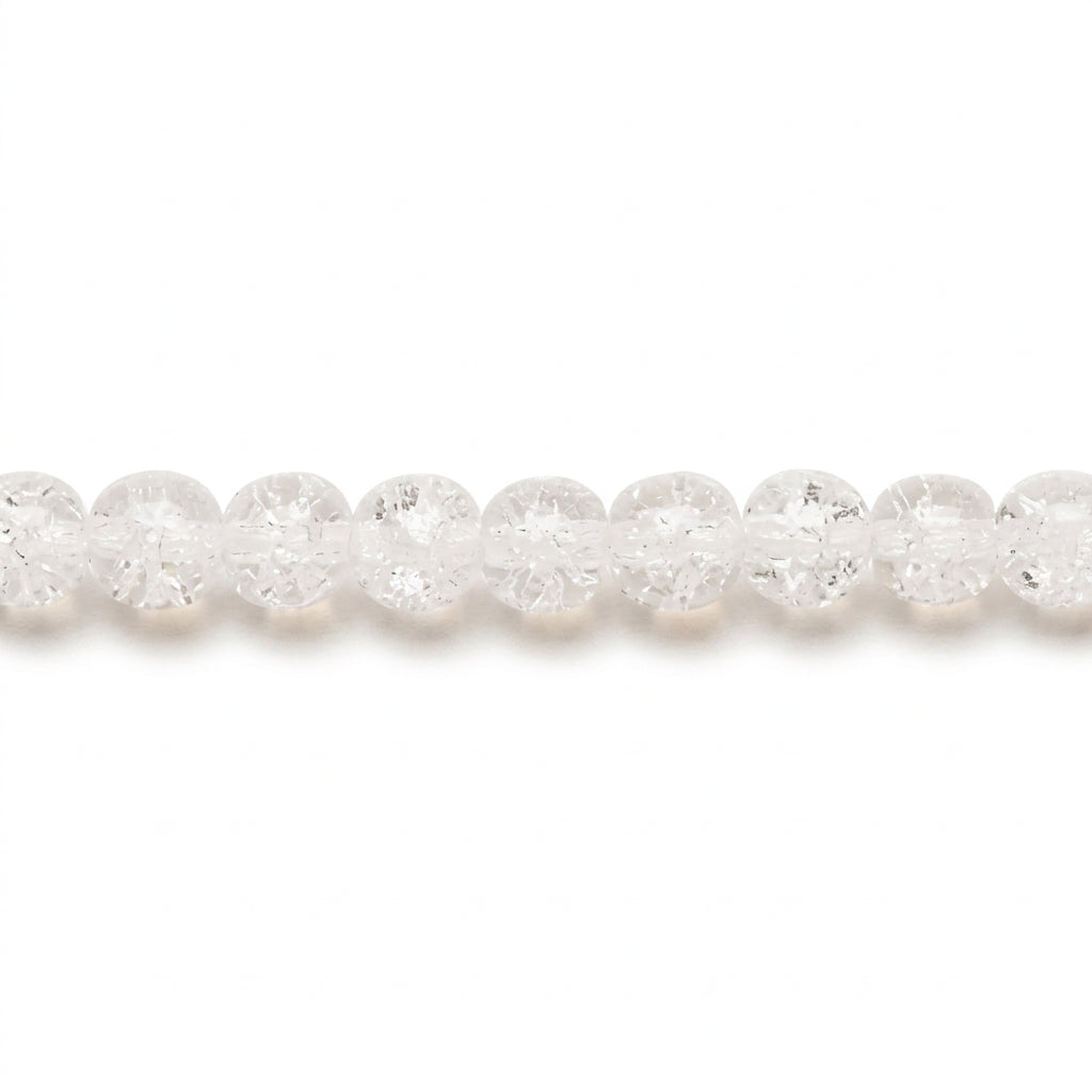 A close-up horizontal view of a strand of faceted, clear round beads on a plain white background.