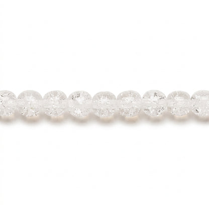 A close-up horizontal view of a strand of faceted, clear round beads on a plain white background.