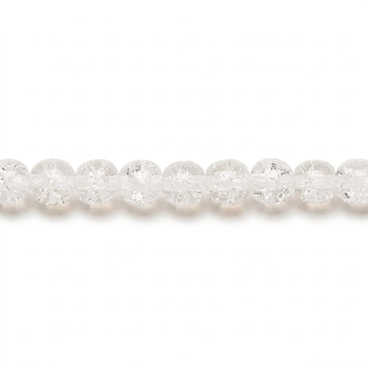 A close-up horizontal view of a strand of faceted, clear round beads on a plain white background.