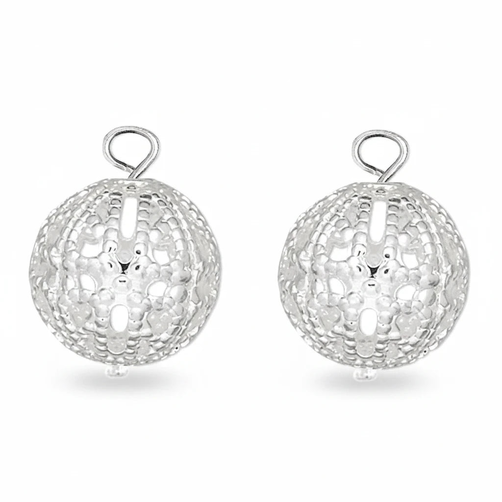 Three silver filigree ball charms with hanging loops, arranged side by side on a plain white background.
