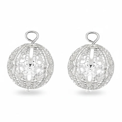 Three silver filigree ball charms with hanging loops, arranged side by side on a plain white background.