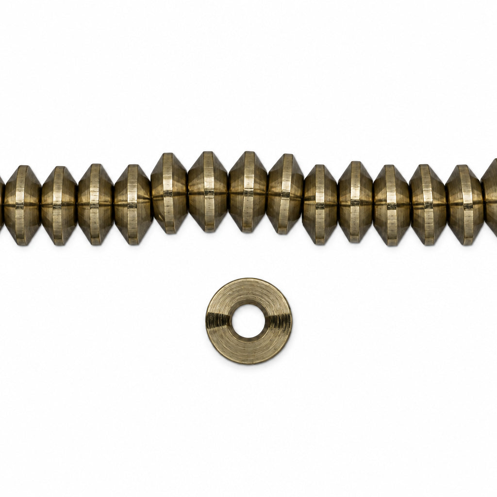 A strand of small metallic gold faceted beads with a matching flat metal washer, shown on a plain white background.