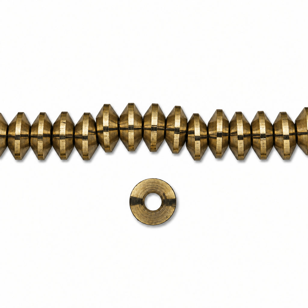 A strand of metallic gold faceted beads with a single matching metal washer shown below on a plain white background.