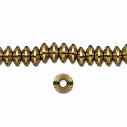A strand of metallic gold faceted beads with a single matching metal washer shown below on a plain white background.
