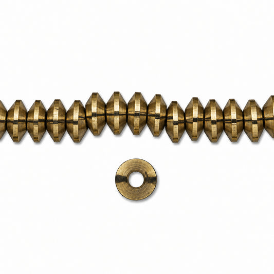 A strand of metallic gold faceted beads with a single matching metal washer shown below on a plain white background.