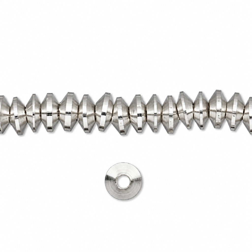 A strand of faceted silver beads with a single flat silver spacer disc below, shown on a plain white background.
