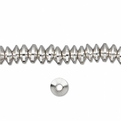 A strand of faceted silver beads with a single flat silver spacer disc below, shown on a plain white background.