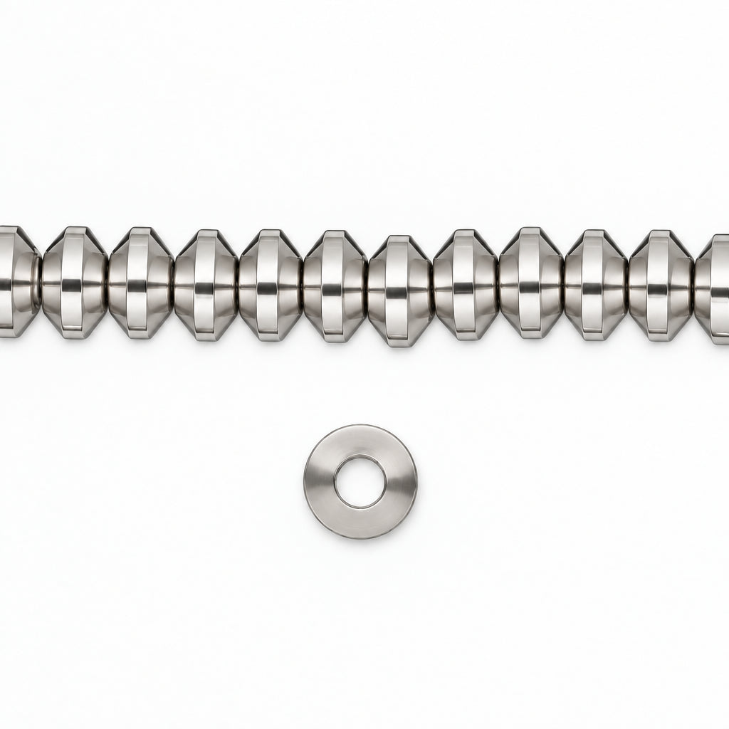 A close-up of a metallic silver beaded strand with a small matching silver washer or spacer below it, shown on a plain white background.