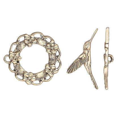 Antique GOLD metal toggle clasp set featuring a floral wreath ring, a hummingbird figure, and a flat bar with a small loop, shown on a plain white background.