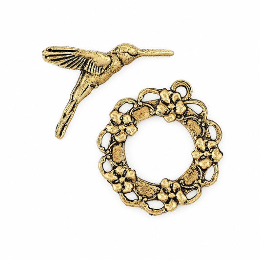 Antique GOLD-finished jewelry findings featuring a detailed hummingbird and a matching floral ring connector, displayed on a clean white background.