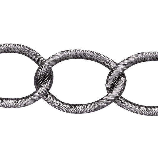 A close-up of a metallic cable chain link, showing the textured, twisted steel wire construction of interlocking oval links on a plain white background.
