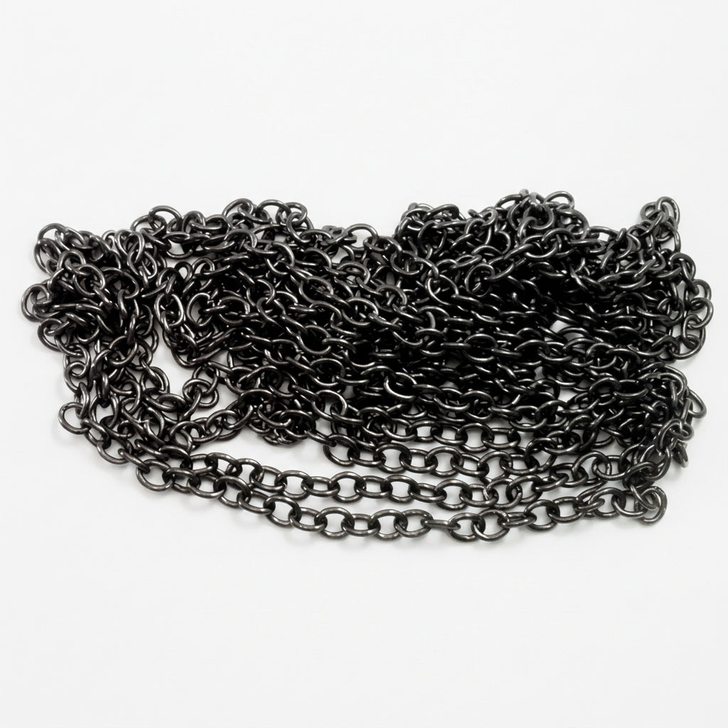 A coiled length of dark metallic chain links, shown on a white background with a US quarter coin for scale.