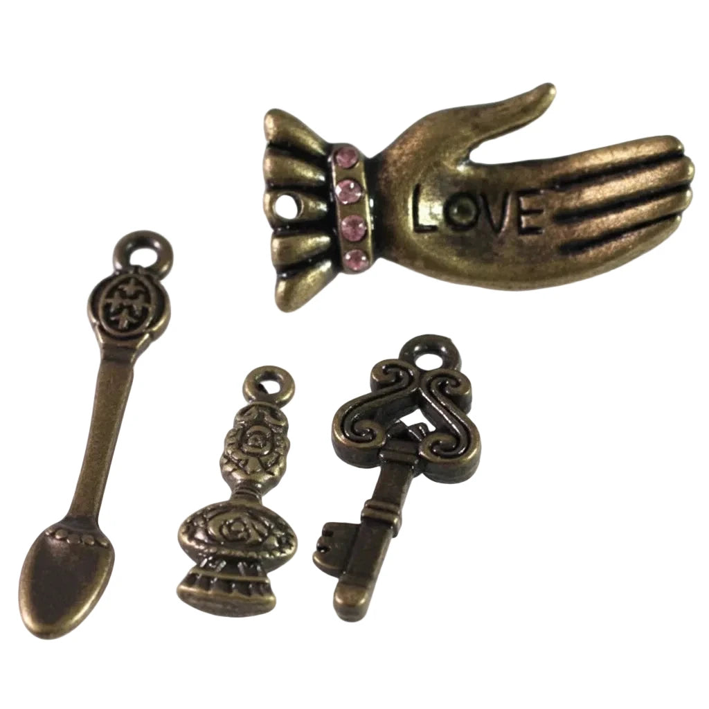 Four antique bronze metal charms for jewelry making, including a hand with pink rhinestones and the word LOVE, a spoon-shaped charm, a decorative urn-shaped charm, and a key-shaped charm, displayed on a white background.