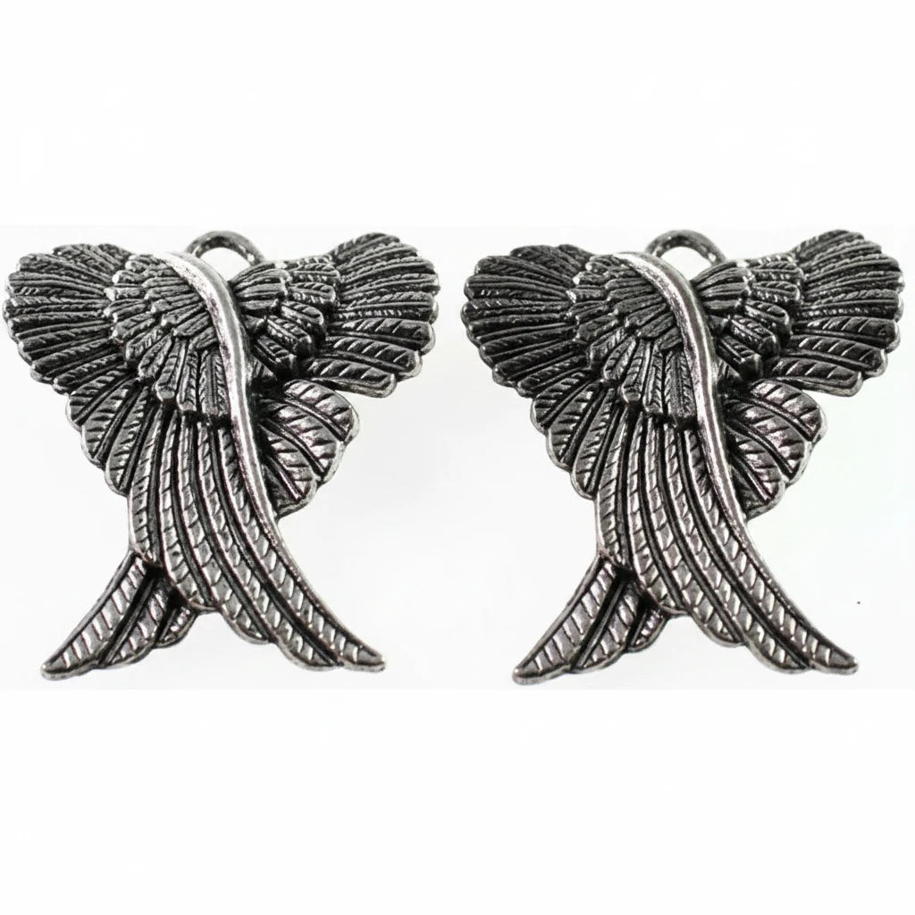 A pair of silver-toned metal wing charms with textured feather details and hanging loops at the top, shown on a plain white background.