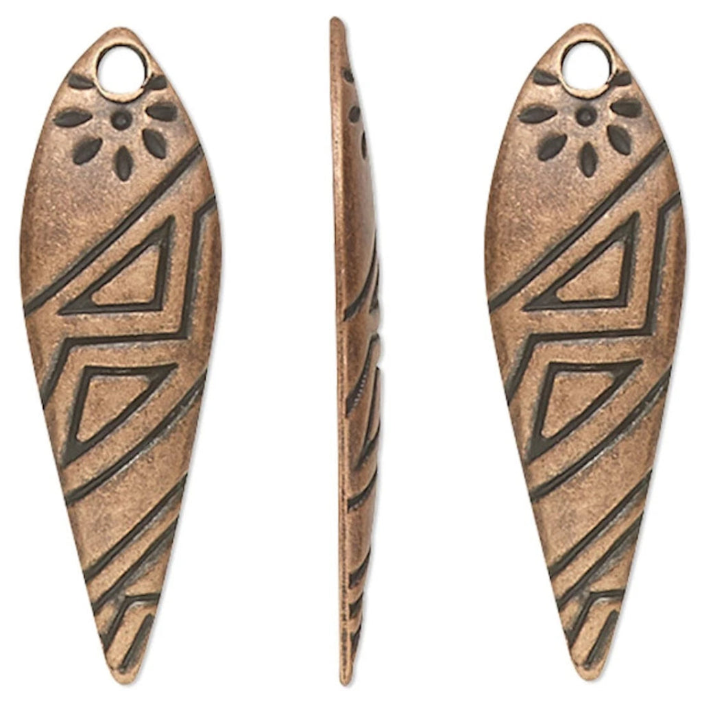 Four views of a single teardrop-shaped metal pendant charm with a textured bronze finish and engraved geometric tribal patterns, shown on a plain white background.