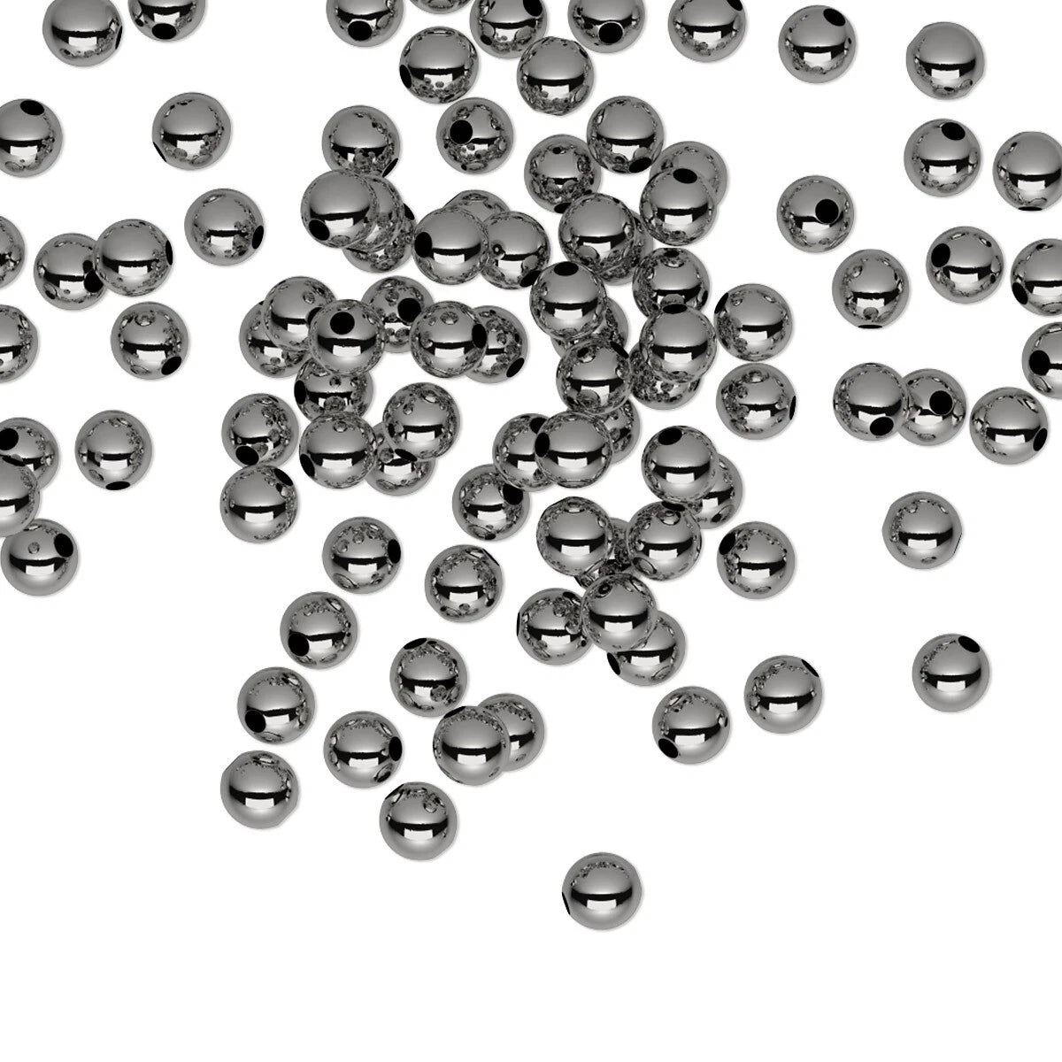 A scattered collection of small, shiny metallic gunmetal beads with a central hole, photographed on a solid white background.