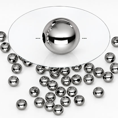 A shiny silver metallic ball bead shown in the center with several smaller matching silver beads scattered around it on a white background.