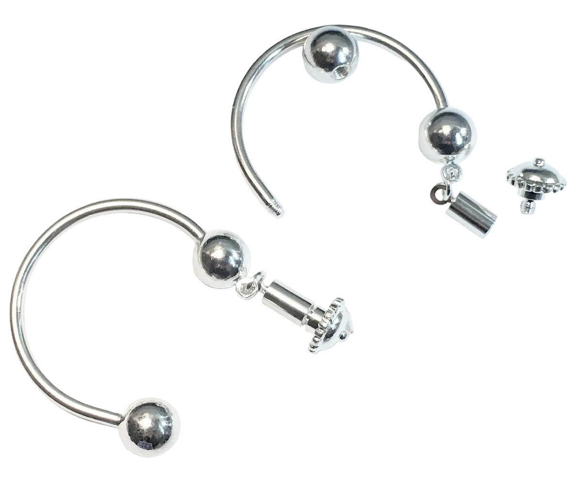 Silver-toned curved hoop earrings with spherical bead details and a small dangling charm, shown on a plain white background.