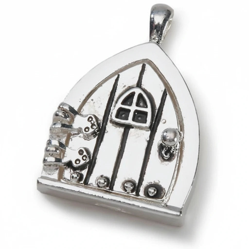A silver fairy door pendant charm with a gothic-style door design, small silver keys, and a bail at the top, shown on a plain white background.