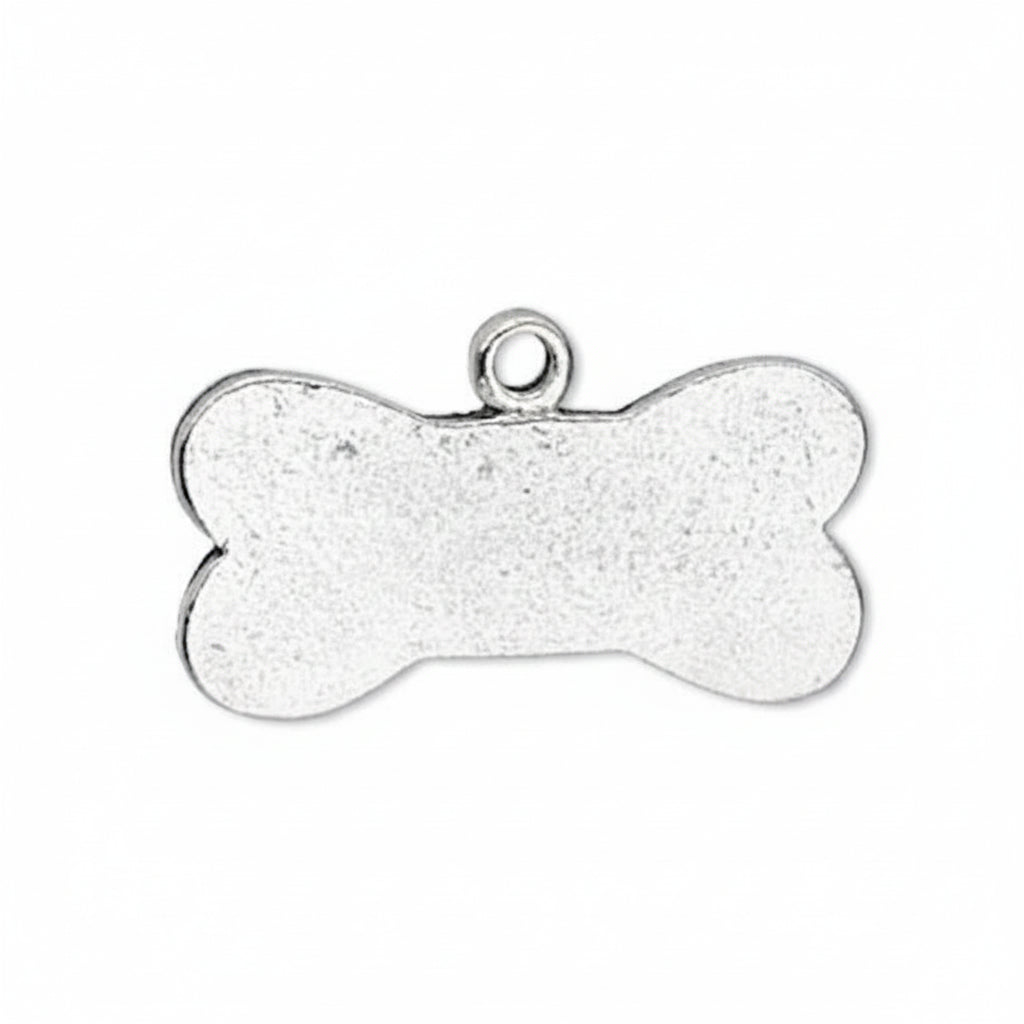 A silver bone-shaped metal pendant or charm with a textured finish and a small loop at the top, shown on a plain white background.