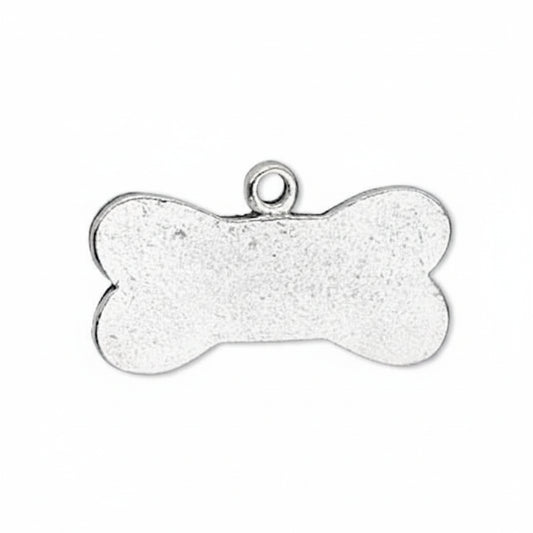 A silver bone-shaped metal pendant or charm with a textured finish and a small loop at the top, shown on a plain white background.