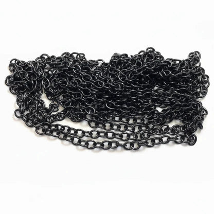A coiled length of black metal chain links, shown next to a US quarter coin for scale, on a plain white background.