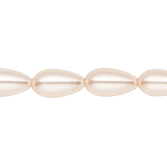 A close-up of a strand of teardrop-shaped freshwater pearls in a soft champagne color, shown against a plain white background.