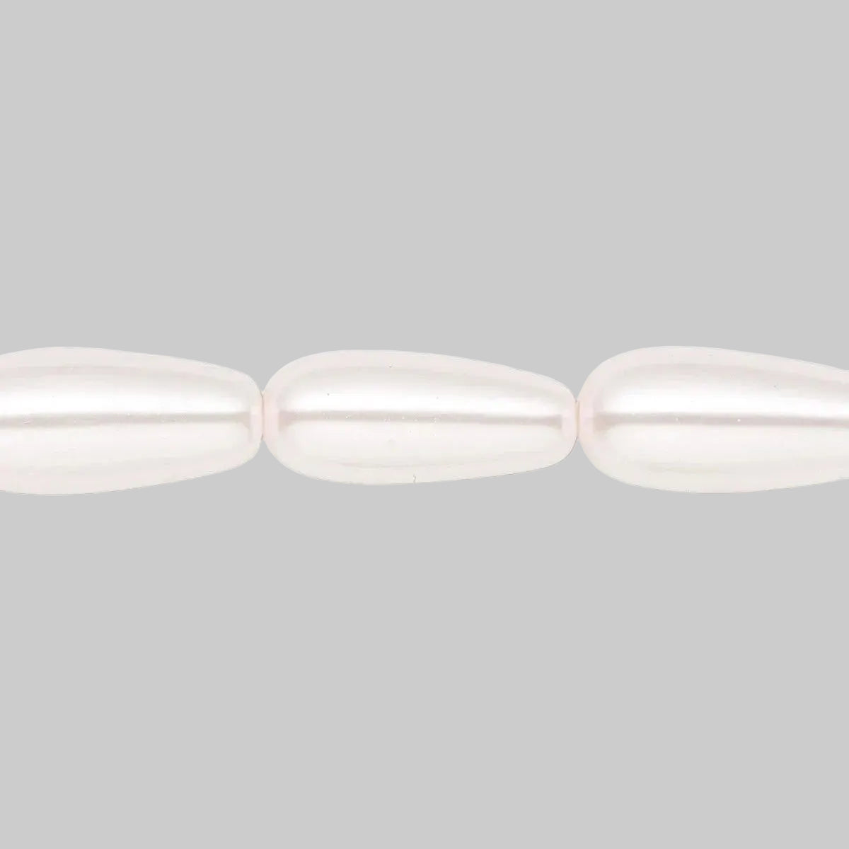 Three elongated teardrop-shaped beads with a lustrous, pearlescent finish in a soft off-white color, shown against a solid white background.