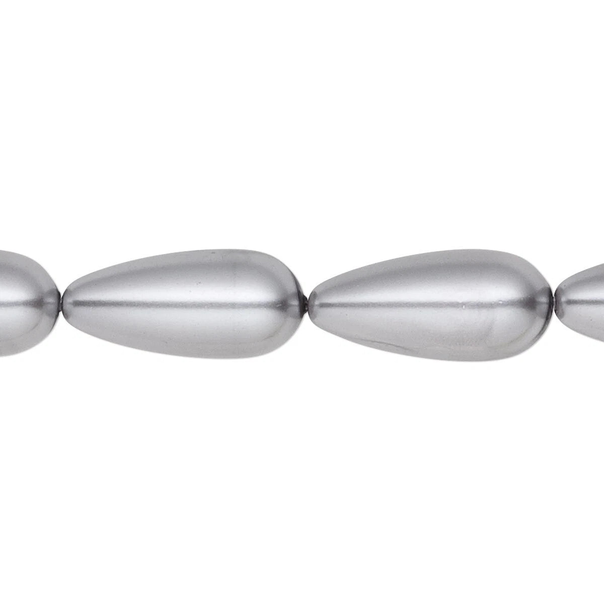 A close-up of metallic silver teardrop-shaped beads on a plain white background.