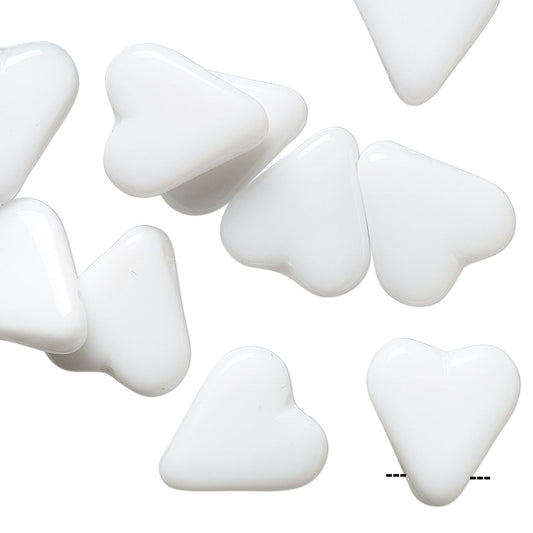 White heart-shaped craft beads scattered on a plain white background.