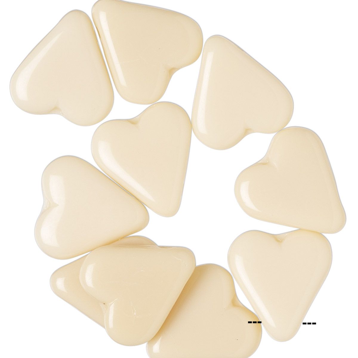A group of glossy, heart-shaped beads in a warm cream or ivory color, arranged in a loose circle on a plain white background.