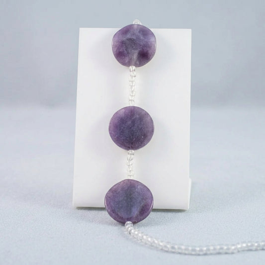 Purple GLASS bead garland with three large polished COIN beads and clear faceted beads, shown against a plain white background.