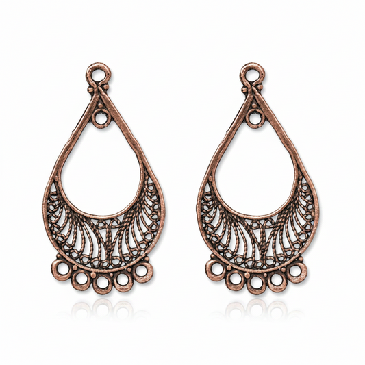 A pair of antique bronze teardrop-shaped filigree jewelry charms on a solid white background.
