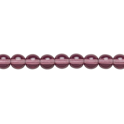 A close-up horizontal line of faceted round beads in a translucent dusty rose or mauve color, set against a plain white background.
