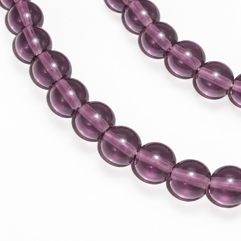 A strand of polished round beads in a deep purple color, shown against a plain white background.