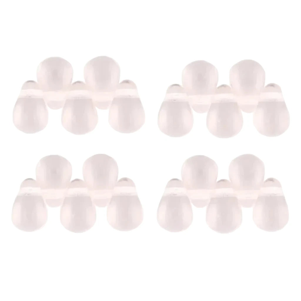 Four pairs of small, translucent, pale pink silicone or plastic dome-shaped beads arranged in a grid on a plain white background.