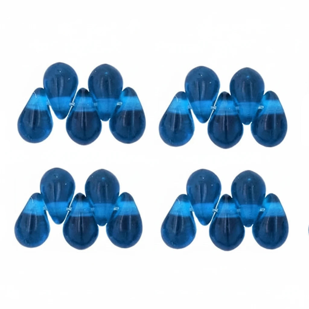 Six pairs of translucent blue teardrop-shaped beads arranged in a grid on a plain white background.