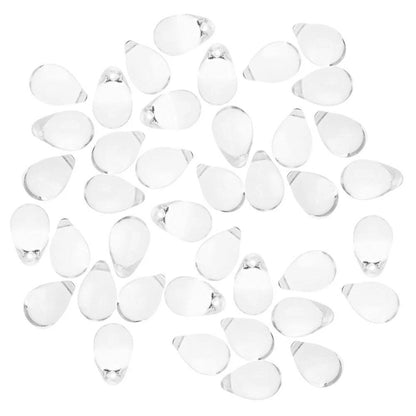 A group of small clear teardrop-shaped glass beads scattered on a plain white background.